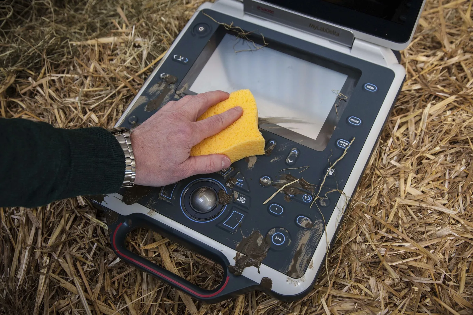 Hybrid HMI panel with physical keys being cleaned with a sponge